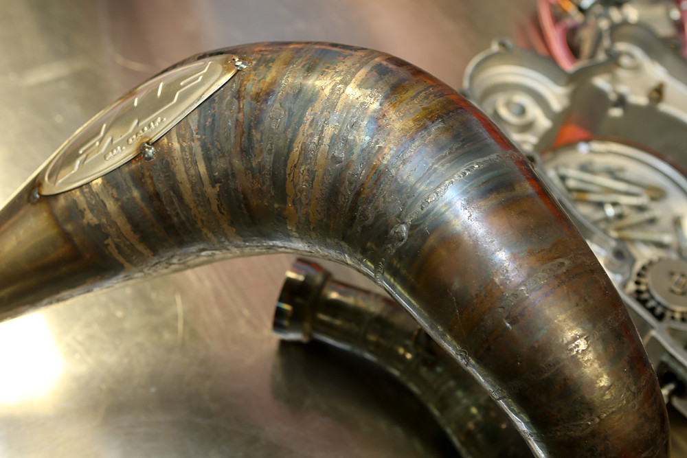KTM tries to maintain continuity between all the teams, including using the same fuel and ignitions, though they're free to use their own exhausts. This one? It's a pipe that KTM is working on for their Orange Brigade amateurs along with FMF.