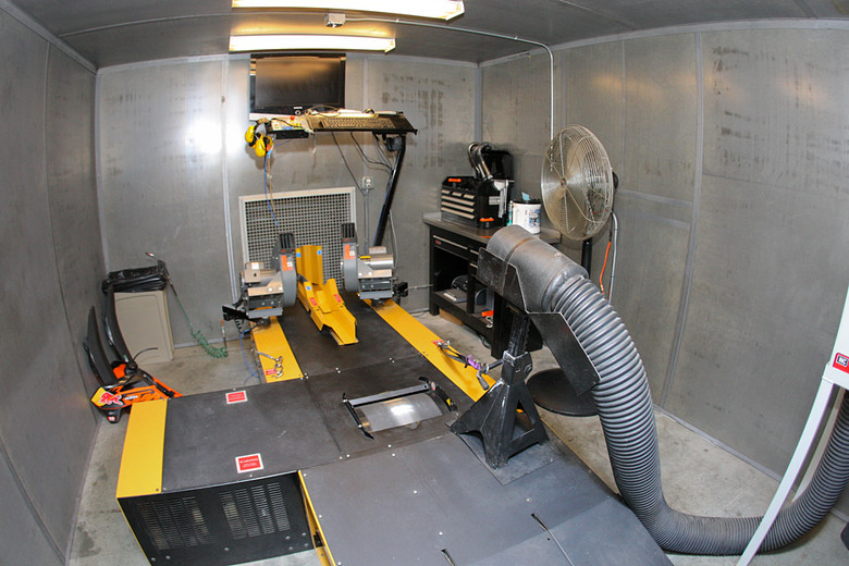 There are two dynos inside KTM's headquarters, both outfitted like this, with the cooling fans, exhaust ducts, and monitors and keyboards easily within reach of the person running them.