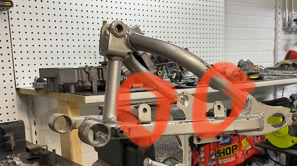 Cut these tabs off to use weld above the shock So that I could use the new style back fender.